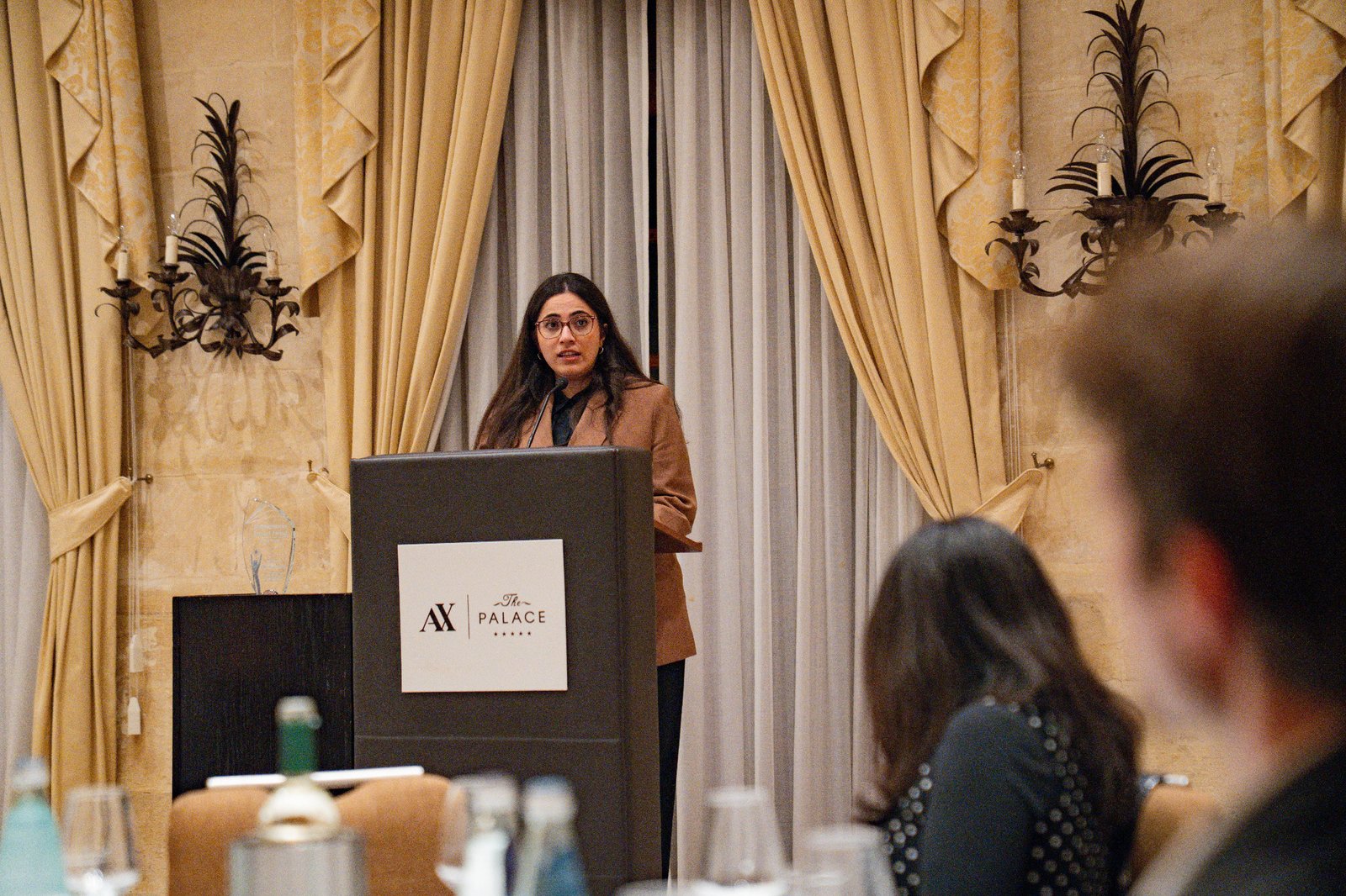 Ghada Alrayan speaking at the ceremony lectern